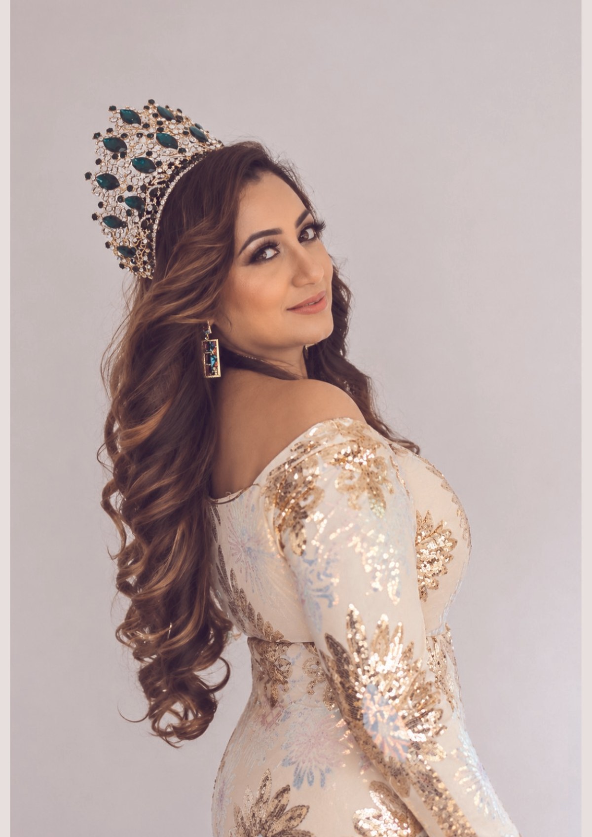 Ashina Singh in her emerald-and-gold crown and cream sequinned gown